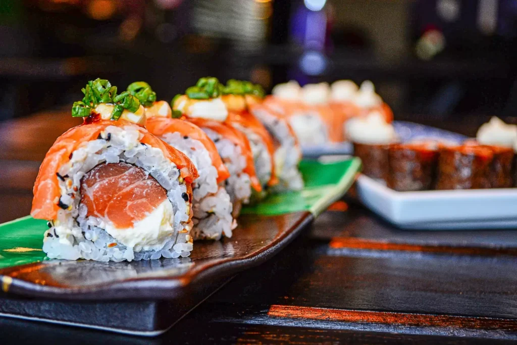 Close-up of salmon sushi rolls on a plate.